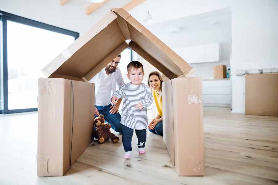 Família brincando com caixas de papelão na mudança